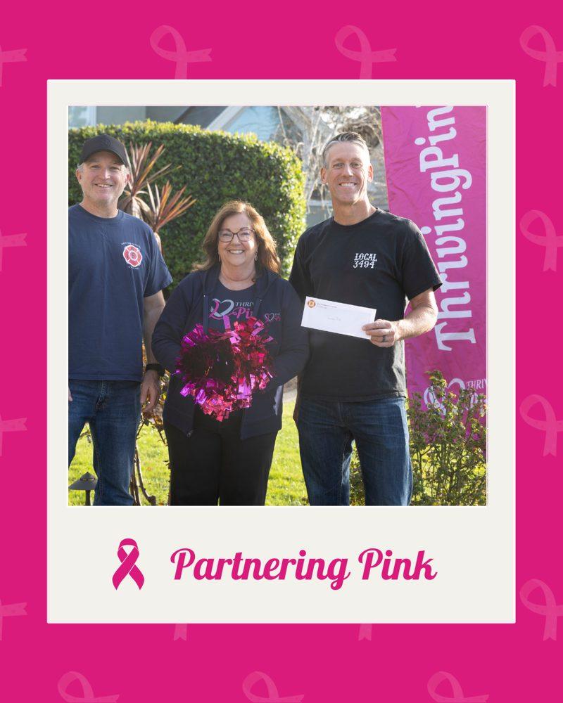 Partnering Pink: three people with a donation check
